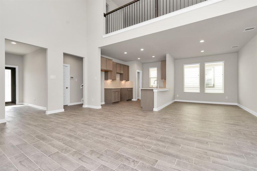 Take another glimpse into the heart of the home with this additional view of the family room—a sprawling space ready to accommodate all your gatherings. Sample photo of completed home with similar floor plan. As-built interior colors and selections may vary.