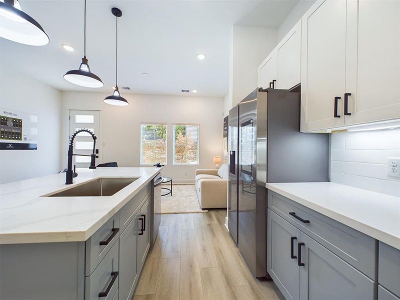 This attractive Kitchen is full of beautiful details. Quartz Countertops, Stainless steel Sink, Stainless Steel Appliances, Recessed Lighting, Undercabinet Lighting, Elegant Cabinetry with Soft Close Drawers and Doors.