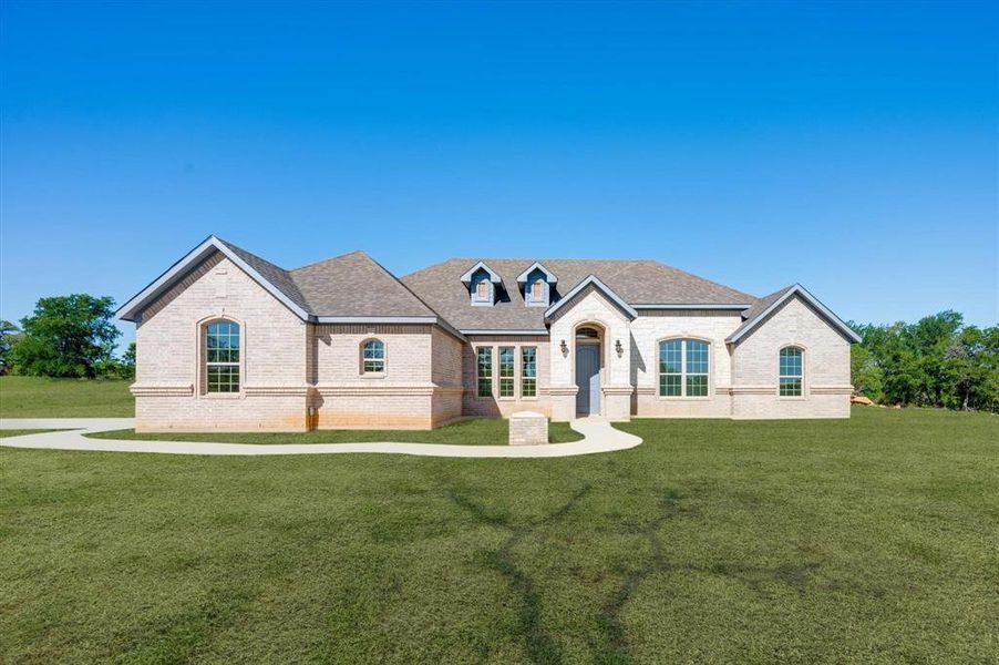 French provincial home with a front yard