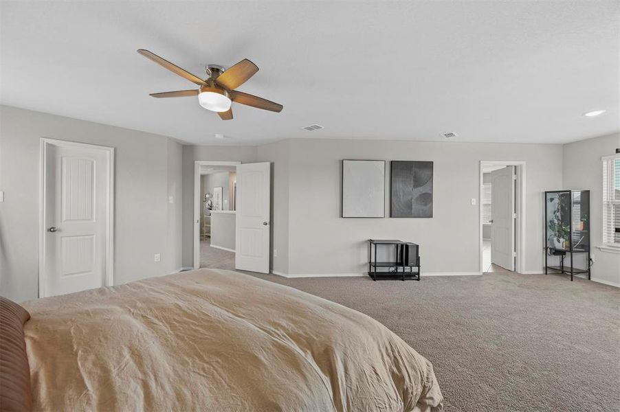 Bedroom with light carpet and ceiling fan