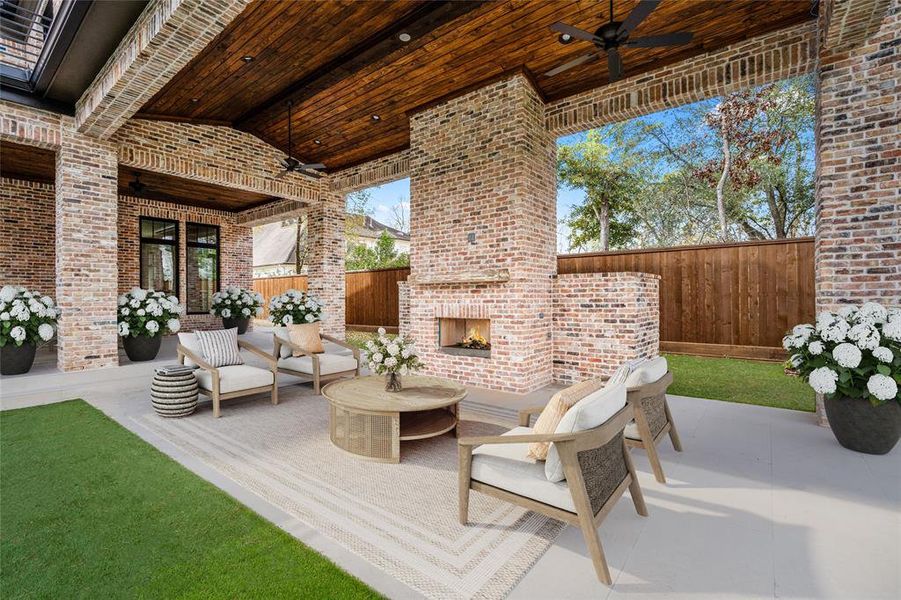 Covered patios with wood-trimmed ceilings, fans and an outdoor fireplace are perfect for all-weather entertaining.