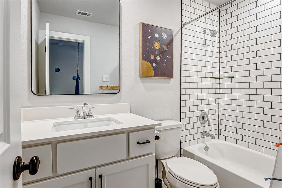 5th full bathroom with custom mirrors, floor to ceiling tile, Schluter trim and beautiful cabinetry.