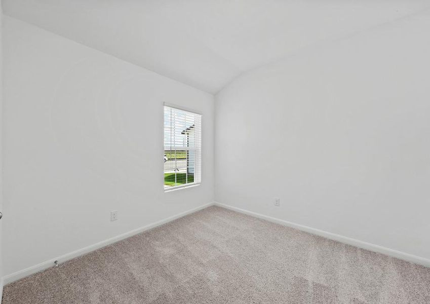 A bedroom with lush grey carpet