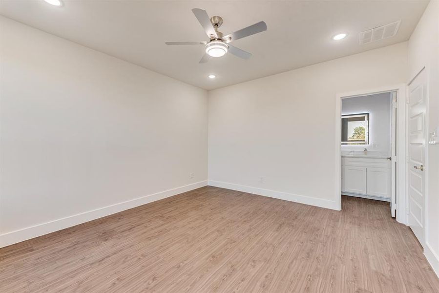 Spare room featuring light wood-type flooring and ceiling fan