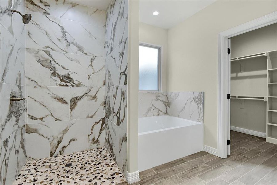 Bathroom featuring shower with separate bathtub and tile patterned floors