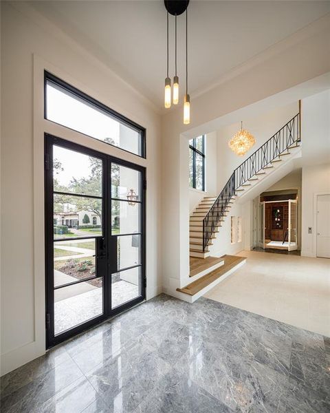 Grand foyer with wrought iron and glass double front door with access to a grand staircase, a reception area leading to the private office