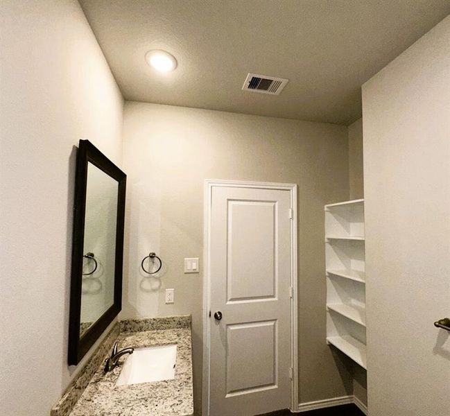 Bath 2 includes granite counters, framed mirror, ceramic tile tub/shower walls & shelving for your linens.