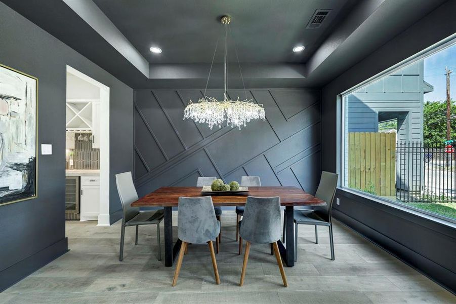 Inviting formal dining with large picture window and built-in accent wall.