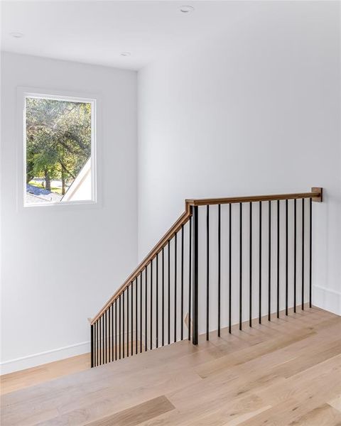 Stairway featuring wood-type flooring