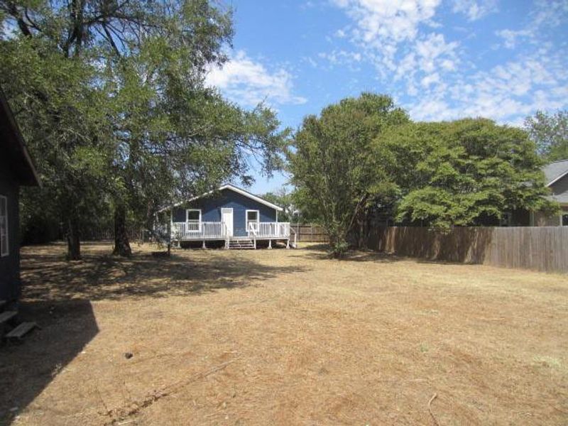 View of yard with a wooden deck