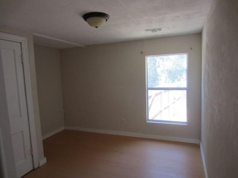 Unfurnished room featuring hardwood / wood-style floors and a healthy amount of sunlight