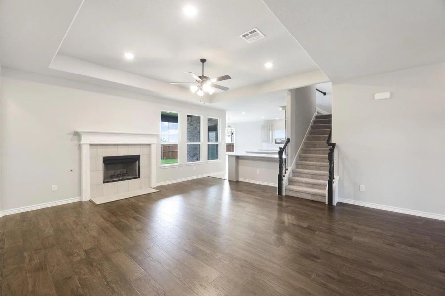 Family Room & Kitchen | Concept 2379 at Abe's Landing in Granbury, TX by Landsea Homes