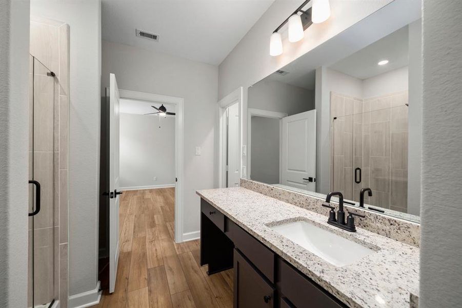 In the en-suite bathroom, a sophisticated vanity sets the tone for elegance, while a separate tub and shower combo offer the height of luxury.