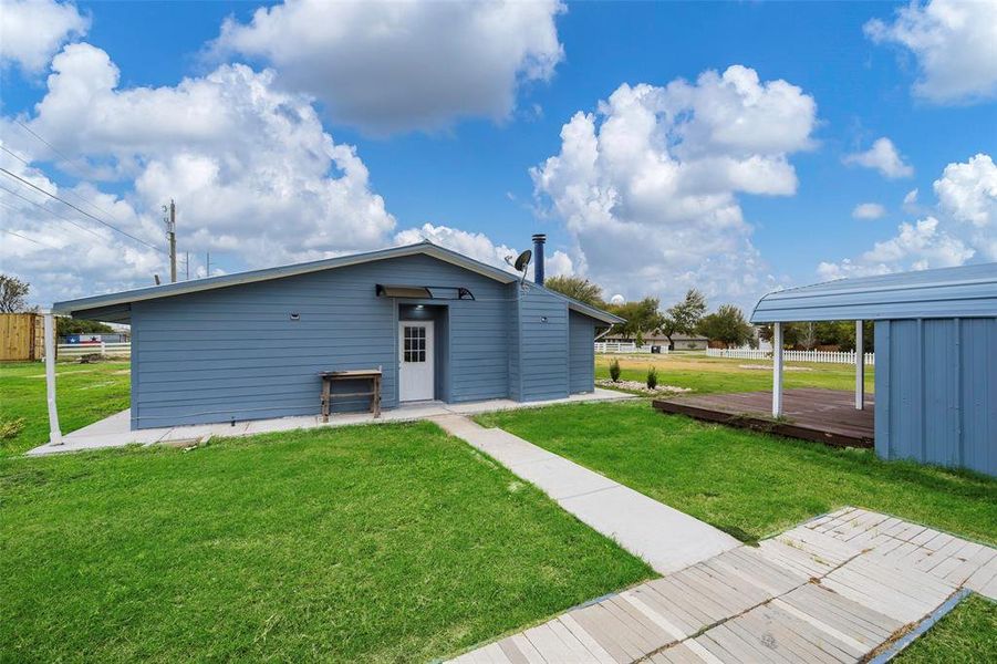 View of outbuilding with a lawn