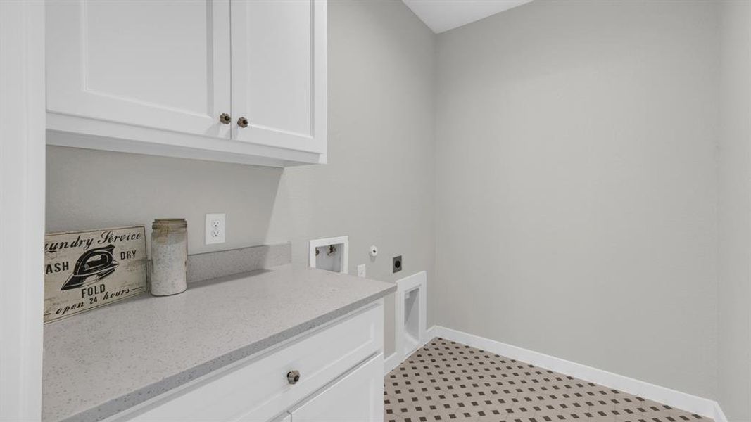 Handy counter space in a dedicated utility room with plenty of cabinet storage.