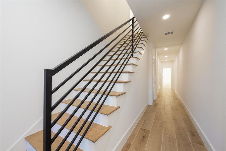 Staircase featuring hardwood / wood-style floors