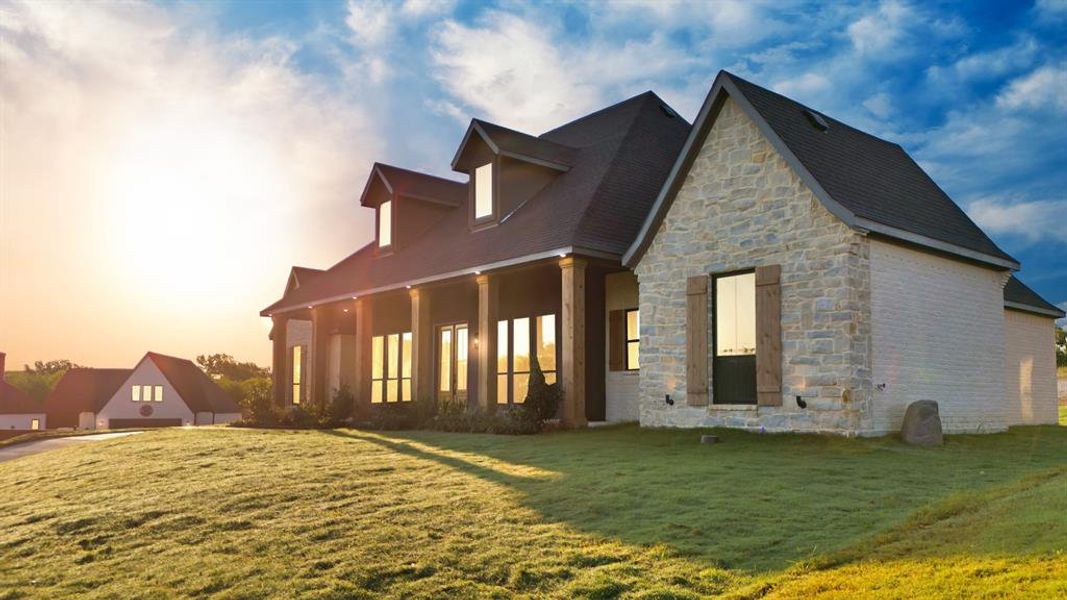 Property exterior at dusk featuring a yard