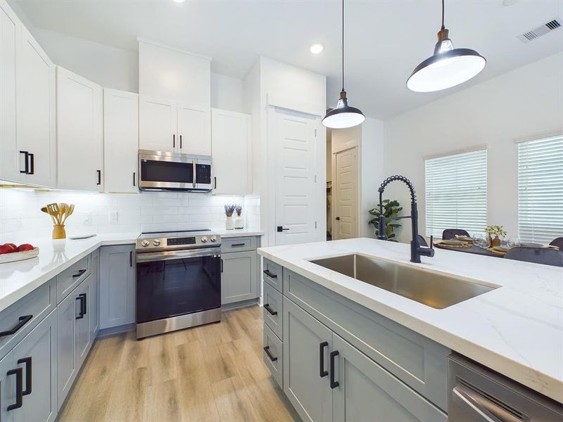 This attractive Kitchen is full of beautiful details. Quartz Countertops, Stainless steel Sink, Stainless Steel Appliances, Recessed Lighting, Undercabinet Lighting, Elegant Cabinetry with Soft Close Drawers and Doors.