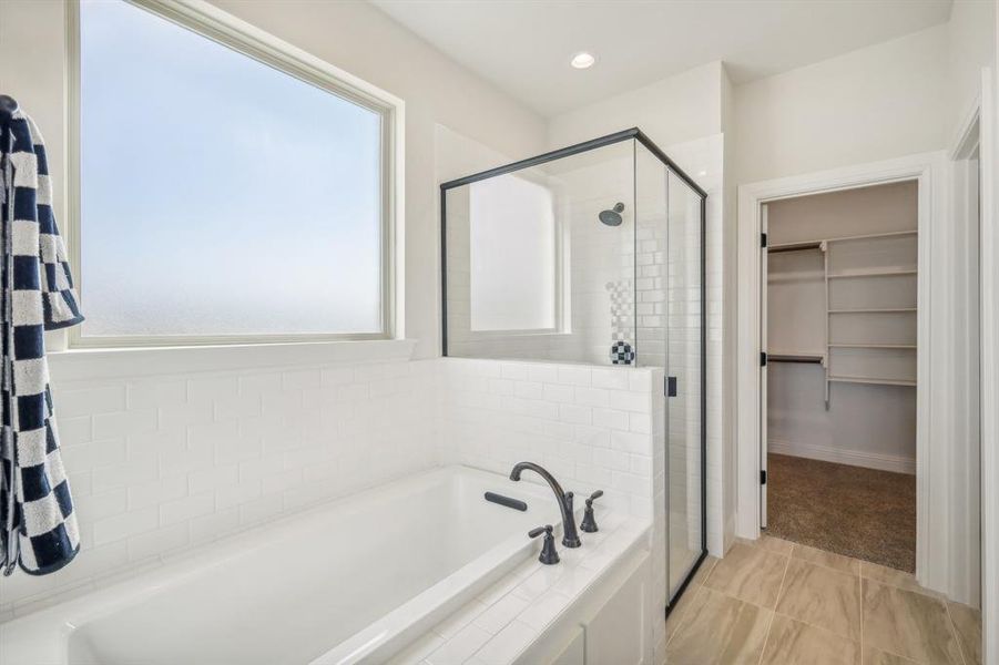 Bathroom with separate shower and tub and tile patterned floors