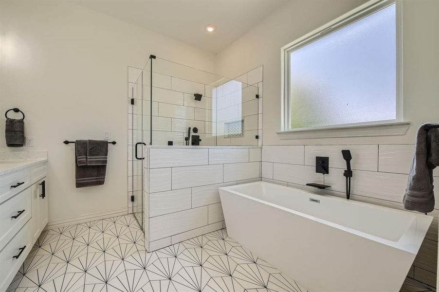 Bathroom with tile patterned flooring, vanity, and plus walk in shower