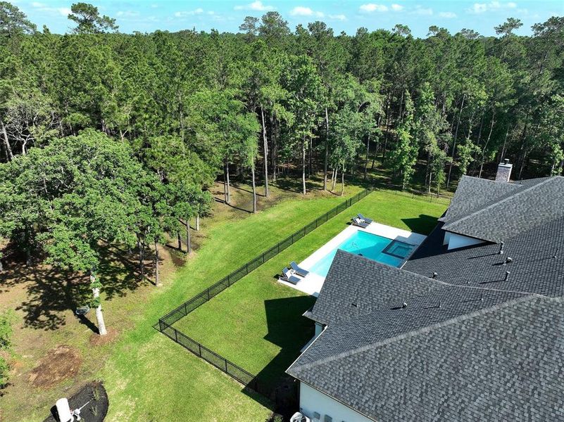 An aerial of the back yard. Your water well will help the sprinkler system keep your grass green!