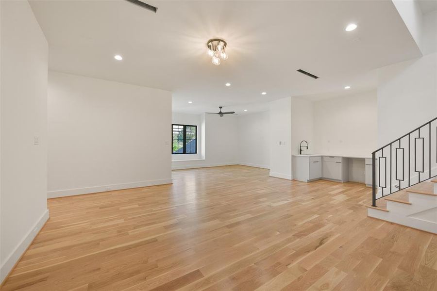 The upstairs game room flows seamlessly with the media. Note the snack bar which has room for a refrigerator or ice maker. There is a large media closet where the wiring throughout the home is run to. It also offers walls of shelving for storage.