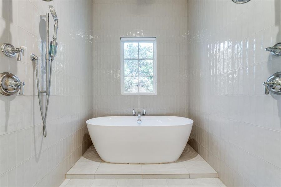 Bathroom featuring tile patterned flooring, tile walls, and independent shower and bath