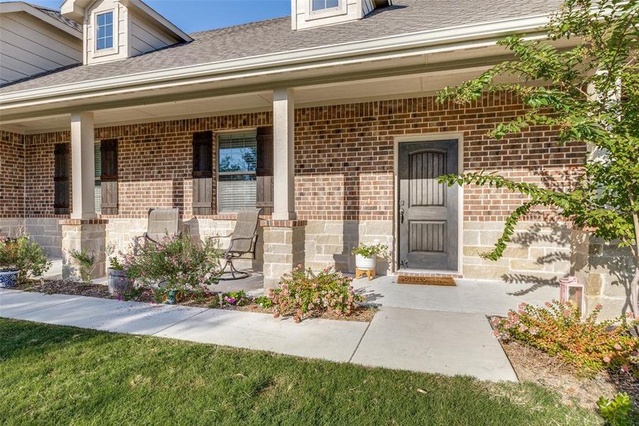 Doorway to property with covered porch