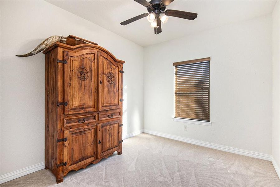 Carpeted bedroom with ceiling fan