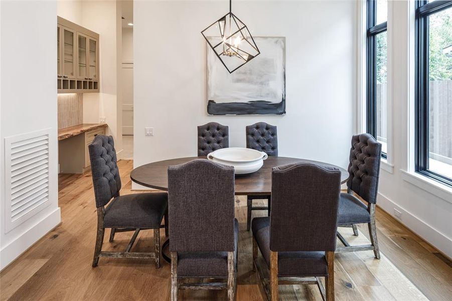 Turn an empty corner of your kitchen into a cozy spacious breakfast nook and designer chandelier