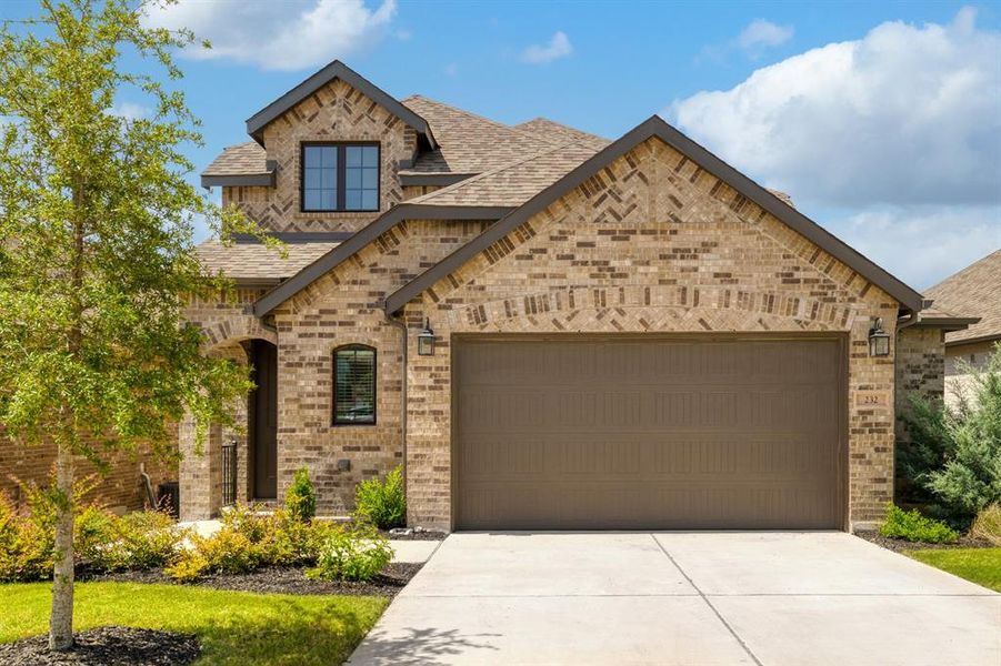 2 Car Garage with interior garage extension and neat landscaping.