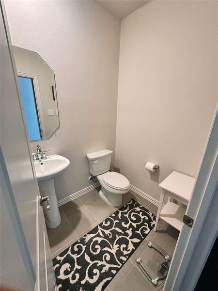 Bathroom featuring tile patterned flooring and toilet