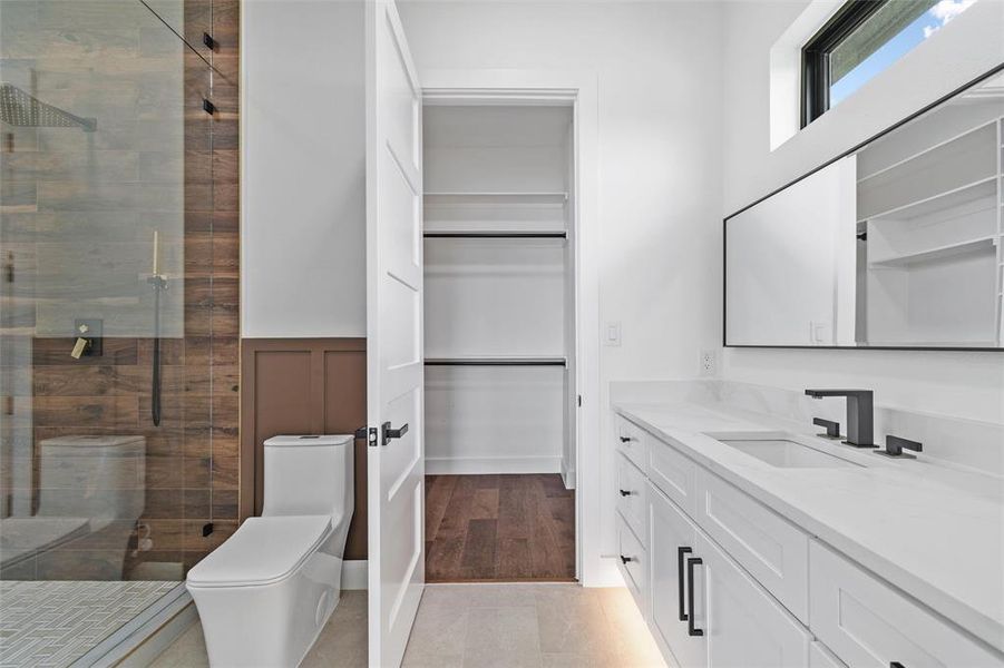 Bathroom with an enclosed shower, hardwood / wood-style floors, toilet, and vanity