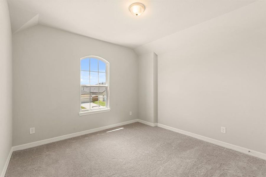 Your secondary bedroom features plush carpet, fresh paint, closet, and a large window that lets in plenty of natural lighting.