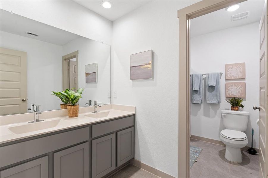 This Home will have the Stunning Bathroom Shaker Cabinets, Double Sinks, Beautiful Vinyl Plank Floors and more! Home is almost ready for you, make that call or just come by the model and let us show you our homes!   **Image representative of plan only and may vary as built**NEW Photos coming soon!