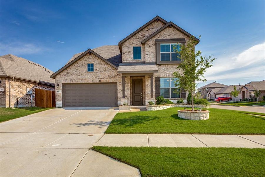 Craftsman-style house featuring a front yard and a garage