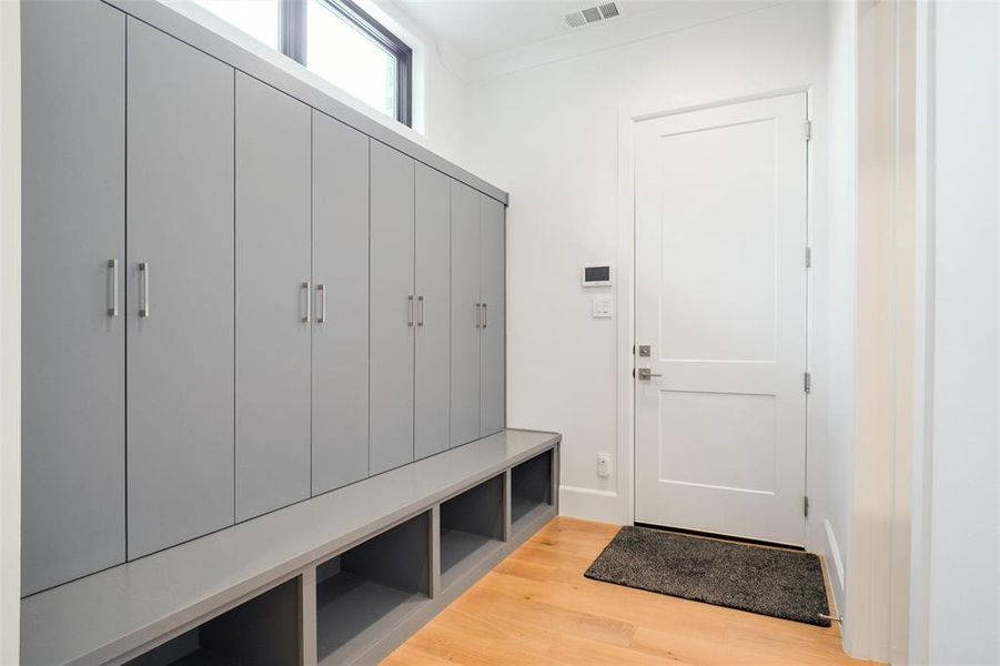 Mud room leading to Garage with Custom 10ft Seating Area with Built-Ins & Coat Closets...