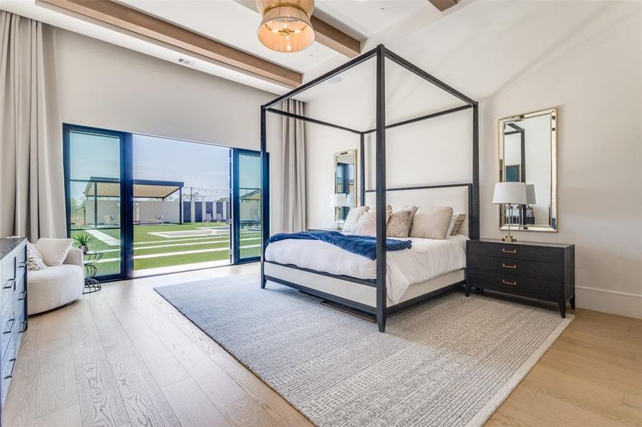 Bedroom featuring beam ceiling, a high ceiling, and wood-type flooring