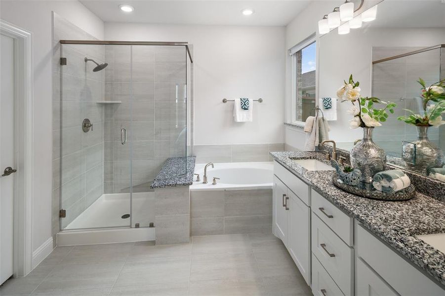 Bathroom featuring tile patterned flooring, separate shower and tub, and vanity