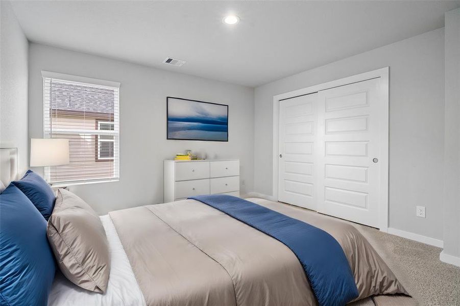 This secondary bedroom features custom paint, plush carpet, and a large window with privacy blinds!