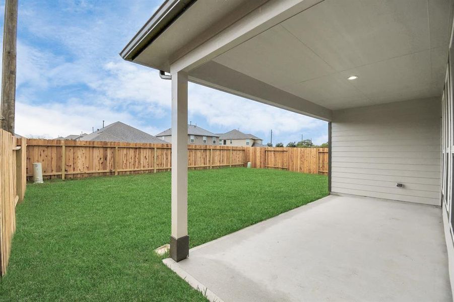 Discover the charm of this spacious backyard featuring a delightful covered patio. With ample room for both play and relaxation, it's the perfect outdoor haven.