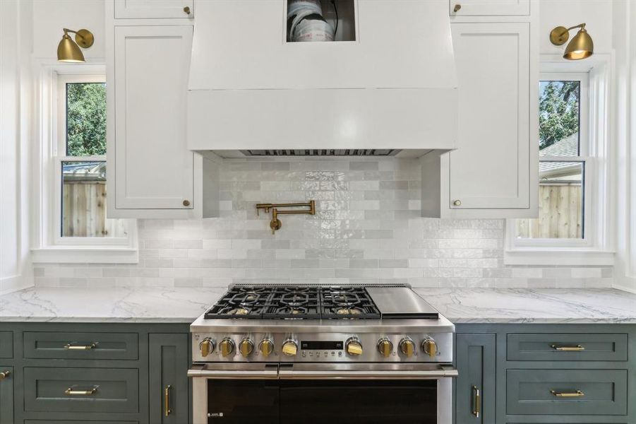 The range is a Professional Series GE Monogram 48" with a griddle - refrigerator is also a 48" GE Monogram Pro Series. (The Ventilation system above is incomplete as of photos / plaster will be applied)