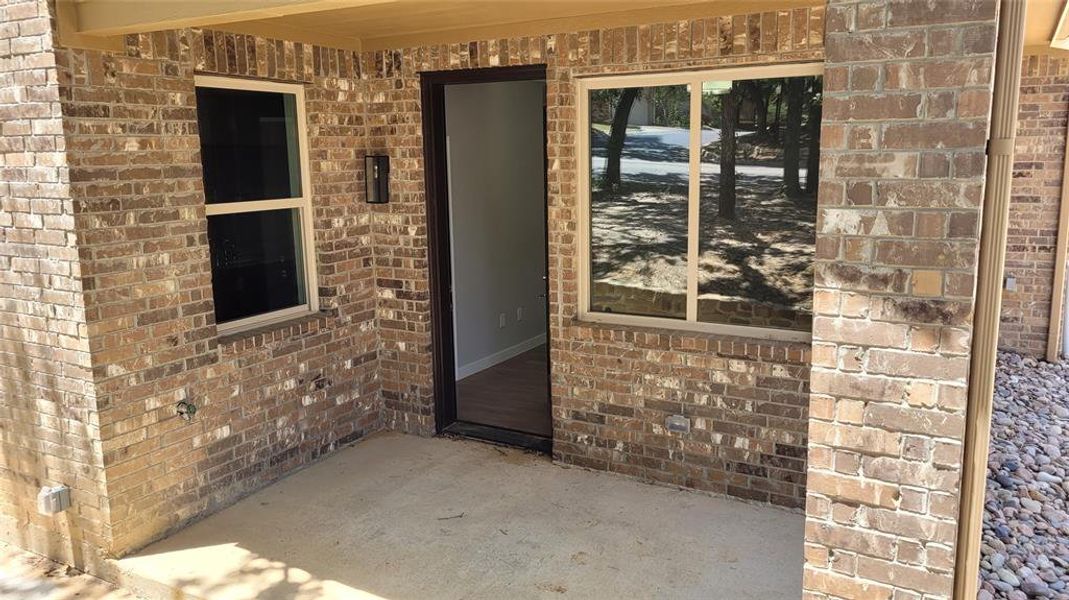 View of private patio entrance to primary bedroom