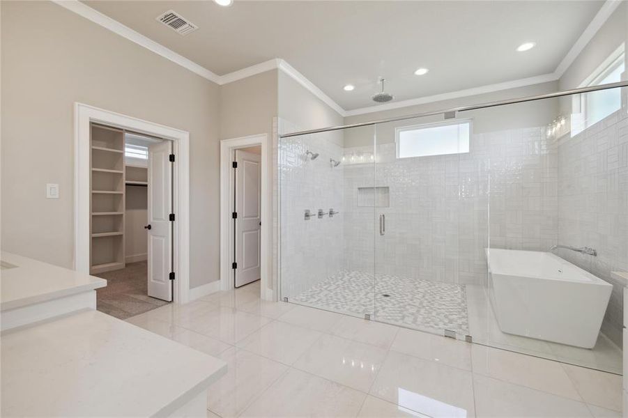 Bathroom featuring ornamental molding, shower with separate bathtub, and tile patterned floors