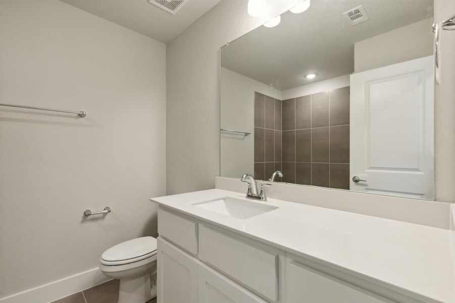 Bathroom with tile patterned flooring, toilet, and vanity