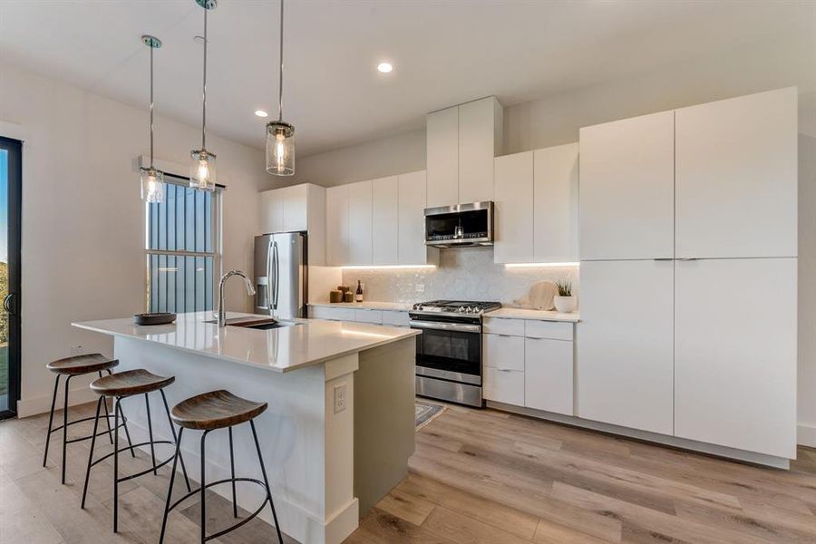 Kitchen with stainless GE appliances. *Model Home*