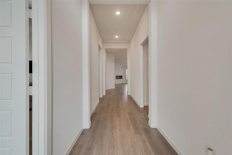 Hallway with light hardwood / wood-style floors