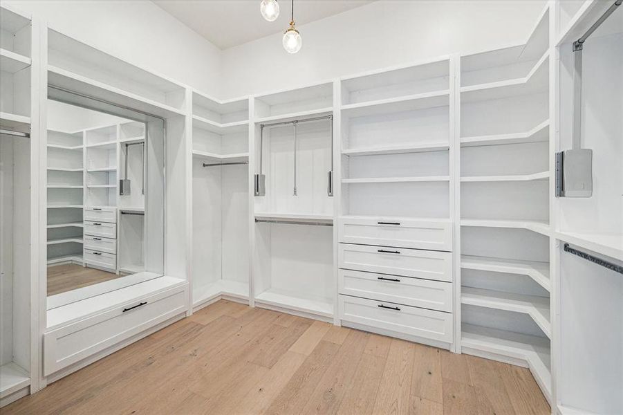 This closet offers generous built-ins, a large mirror, and smart design, including pull-down racks, to keep your clothes and shoes organized without breaking a sweat