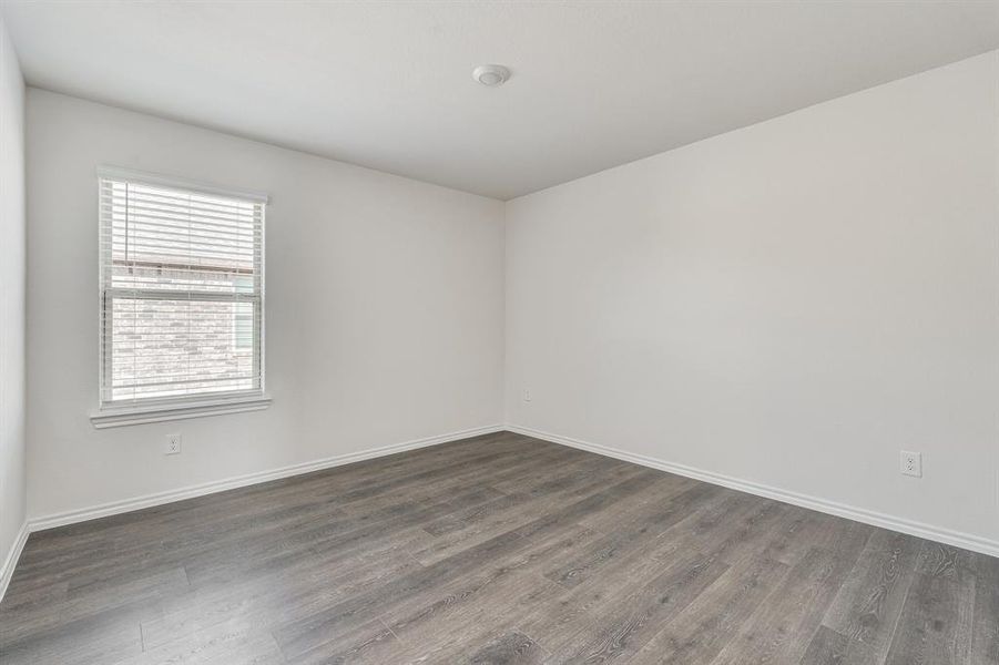 Unfurnished room featuring dark hardwood / wood-style flooring