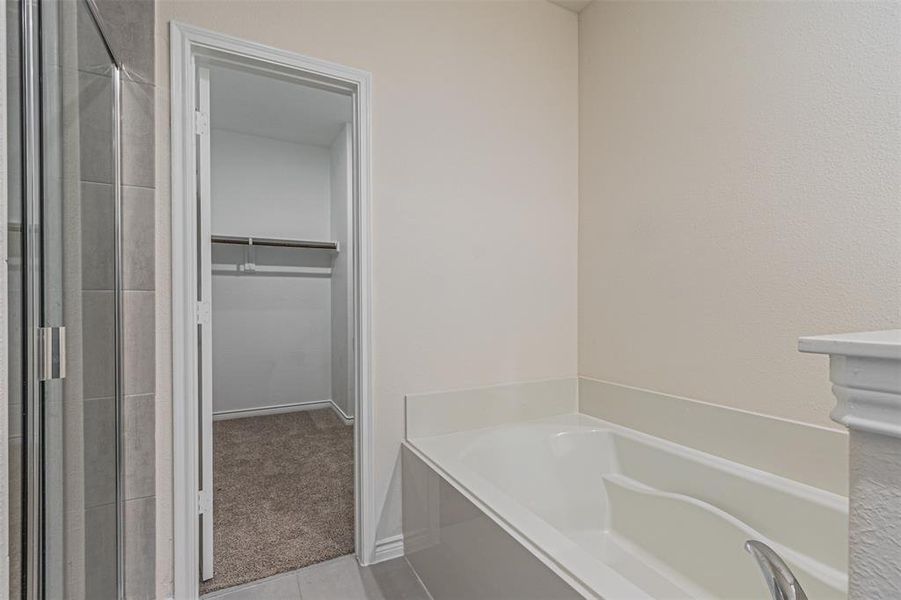 Bathroom featuring tile patterned floors and plus walk in shower